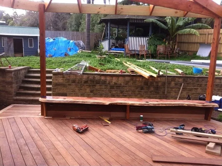 Build stage of the merbau deck and pergola with the live-edge bench seat being fitted
