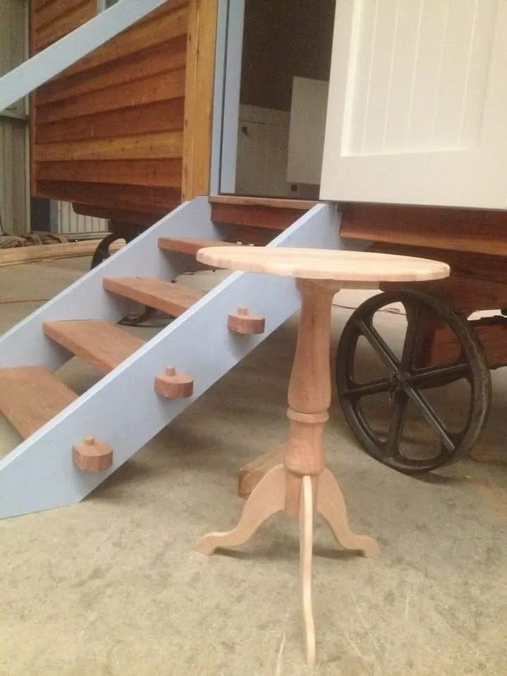 Hand-turned timber pedestal side table in the workshop, unfinished and ready for oiling