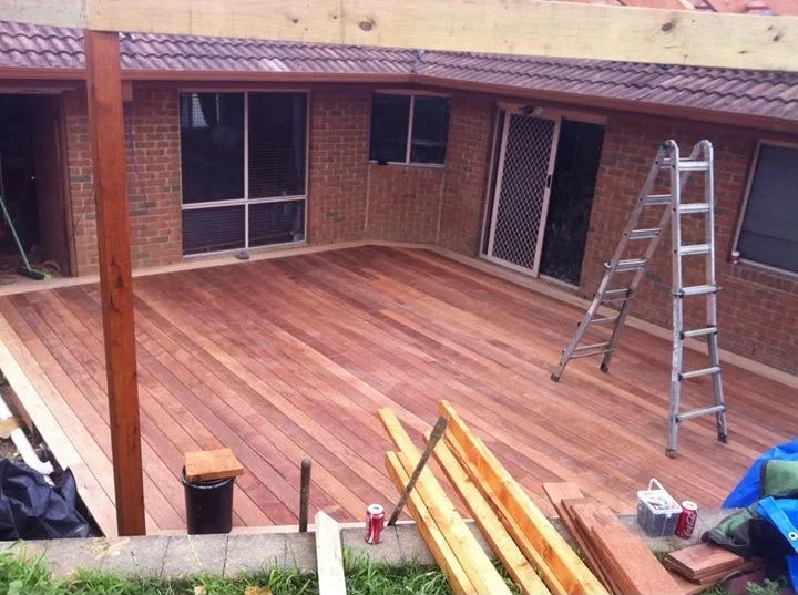 Freshly laid merbau deck under a new verandah frame at the rear of a brick home