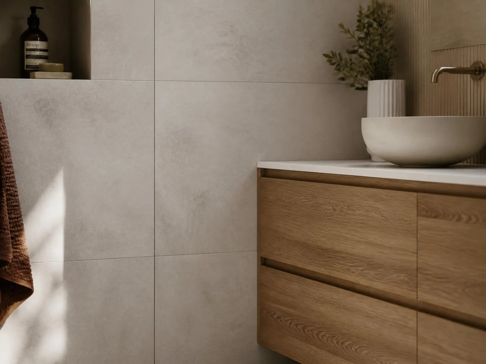 Large-format stone-look wall tiling set with crisp grout lines above a timber vanity