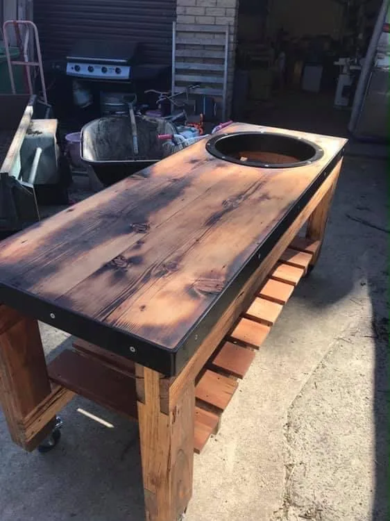 Recycled timber barbecue table with charred top, steel edging and a kettle cut-out