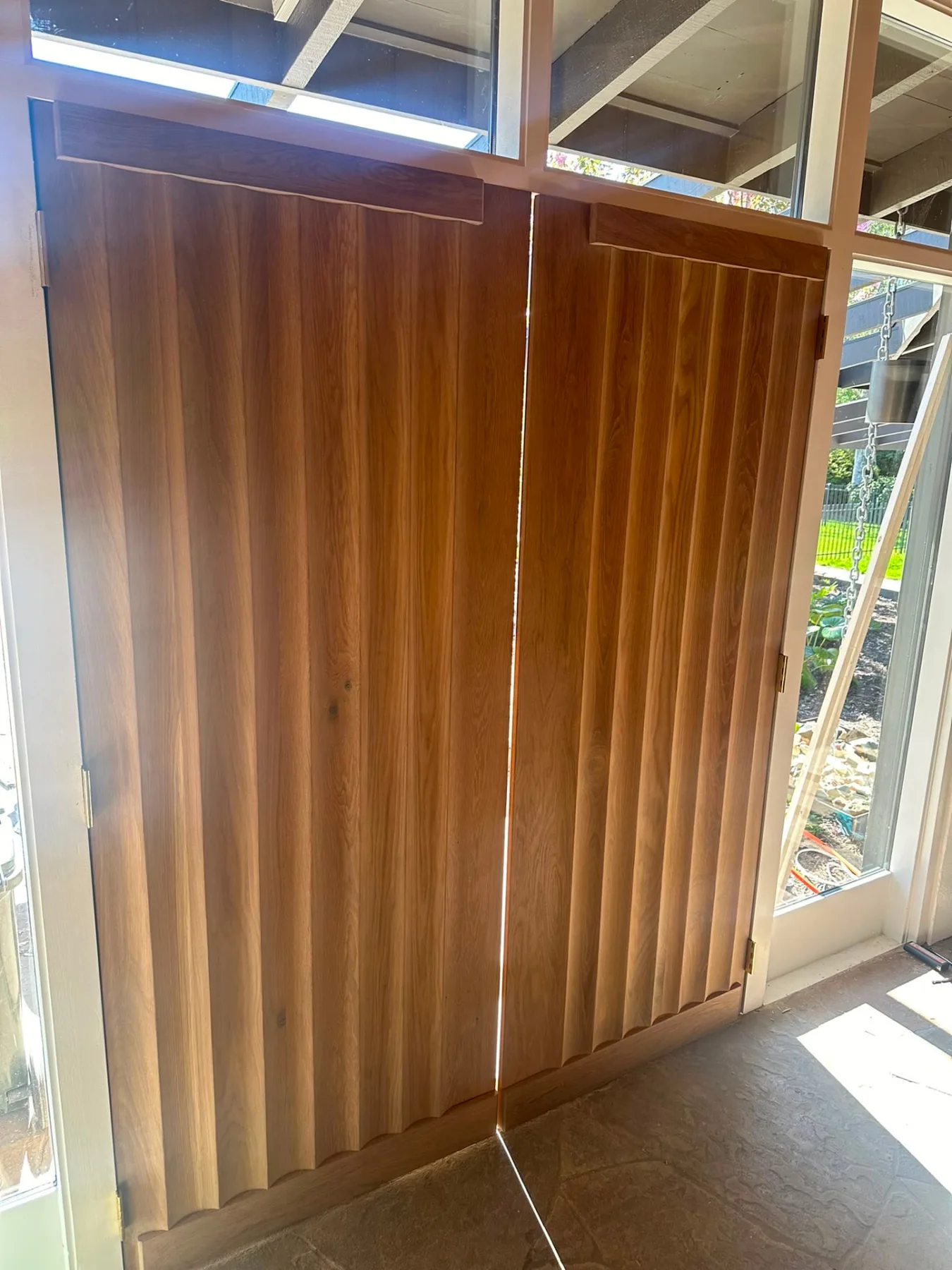Bespoke fluted solid timber doors hung in a mid-century home, finished with a clear oil