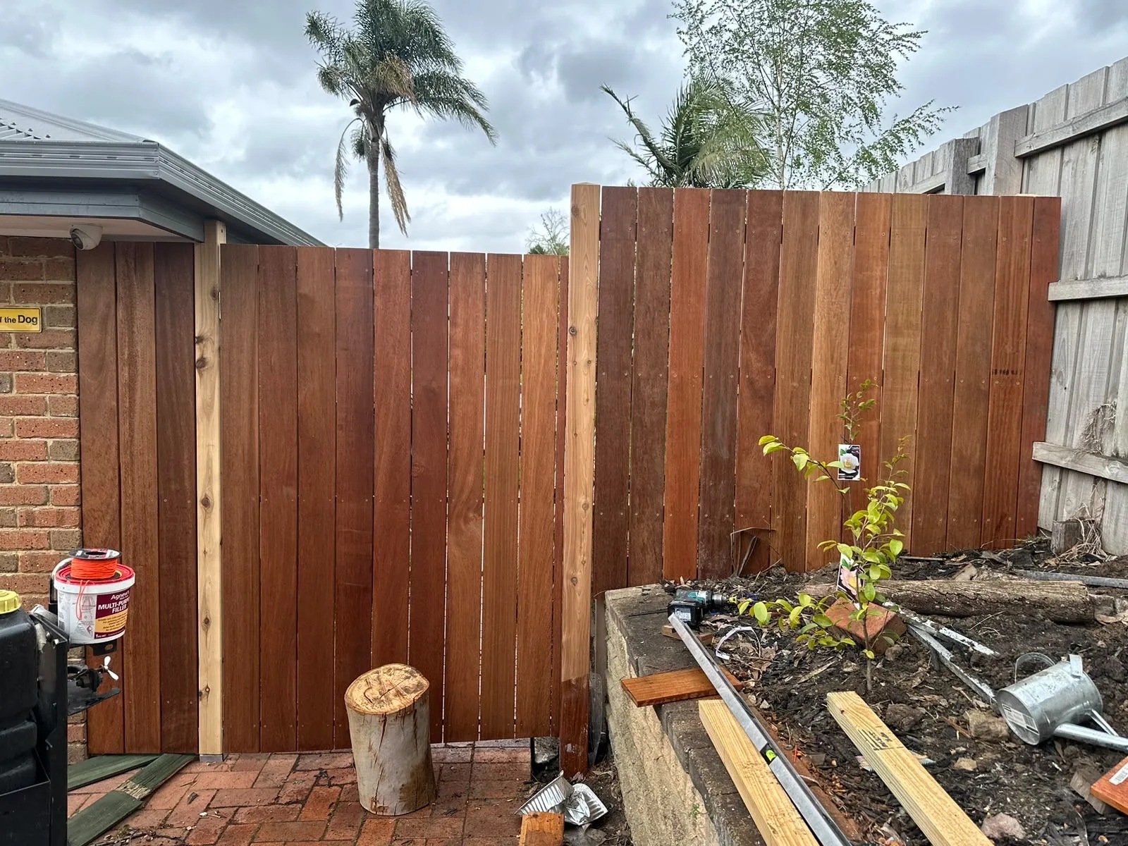 New merbau fence and matching gate replacing paling fencing beside a garden bed
